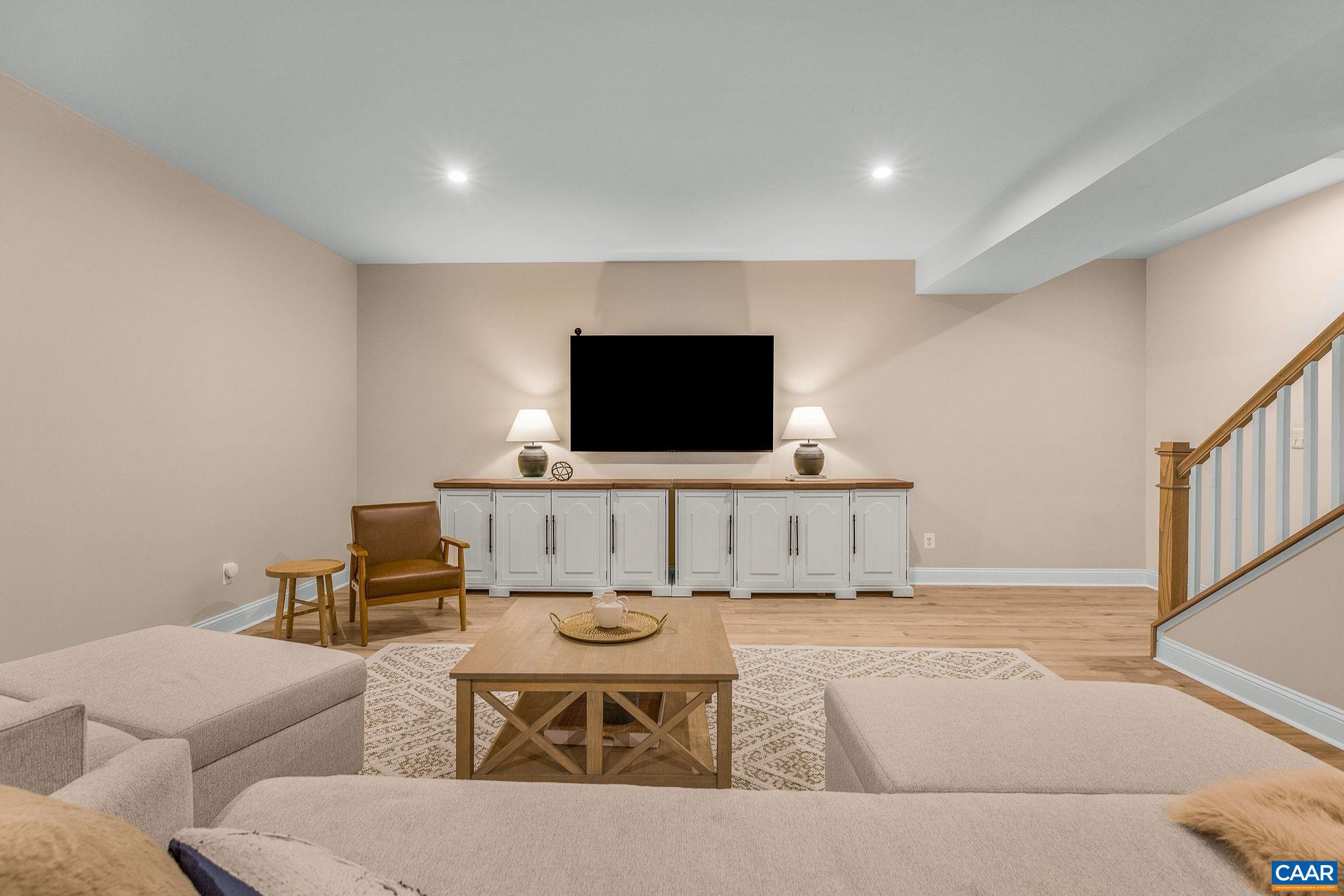 2744 Lockerbie Lane Keswick, VA 22947 - Photo 37 of 75 a living room with furniture and a flat screen tv