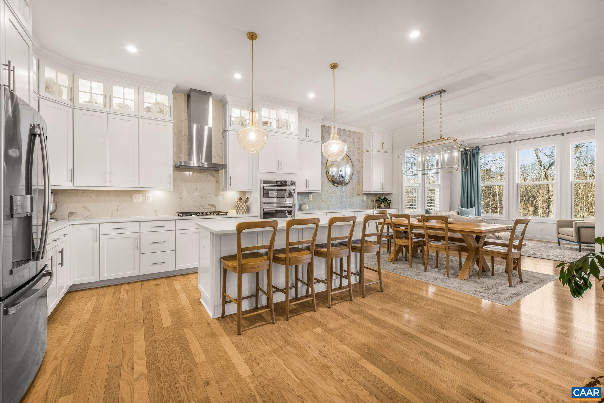 2744 Lockerbie Lane Keswick, VA 22947 - Photo 10 of 75 a large dining hall with stainless steel appliances granite countertop a stove a sink a dining table chairs and view living room