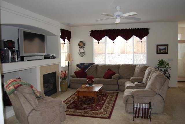 1680 Canyonlands Way Reno, NV 89521 - Photo 2 of 9 a living room with furniture a large window and a fireplace