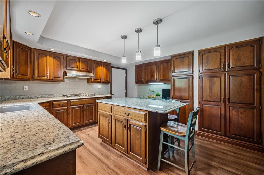 2387 Harrison City Road Export, PA 15632 - Photo 11 of 48 a kitchen with granite countertop a sink appliances and cabinets
