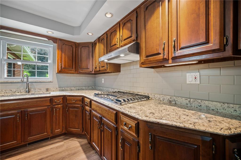 2387 Harrison City Road Export, PA 15632 - Photo 13 of 48 a kitchen with granite countertop a sink stove and cabinets