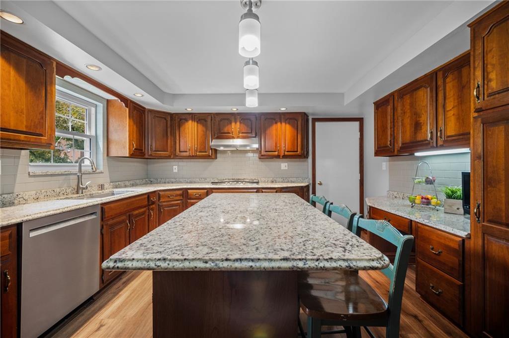 2387 Harrison City Road Export, PA 15632 - Photo 14 of 48 a kitchen with a stove a sink a refrigerator dining table and chairs