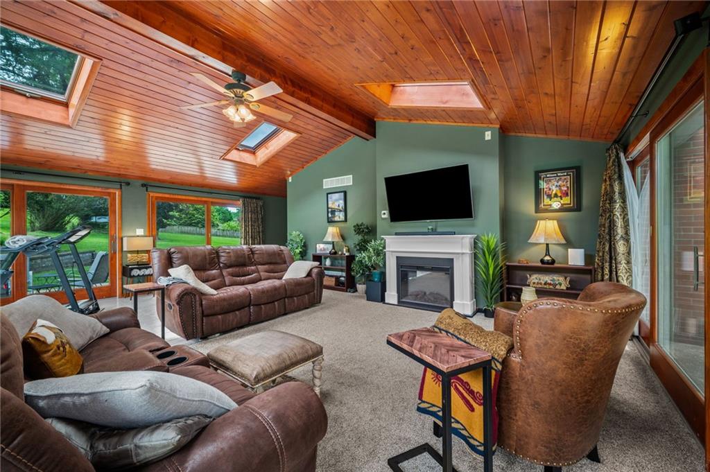 2387 Harrison City Road Export, PA 15632 - Photo 20 of 48 a living room with furniture a fireplace and a flat screen tv