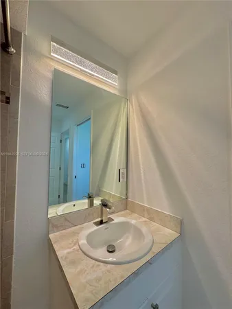 a bathroom with a sink and a mirror