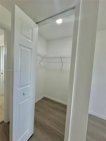 a view of a room with wooden floor