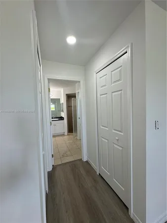 a view of hallway with wooden floor
