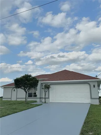a view of a street with a house in the background