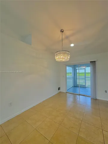 a view of empty room with windows and ceiling fan