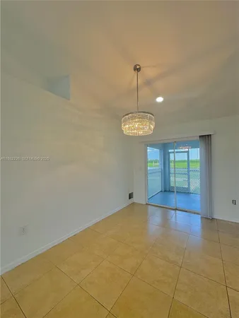 a view of empty room with windows and ceiling fan
