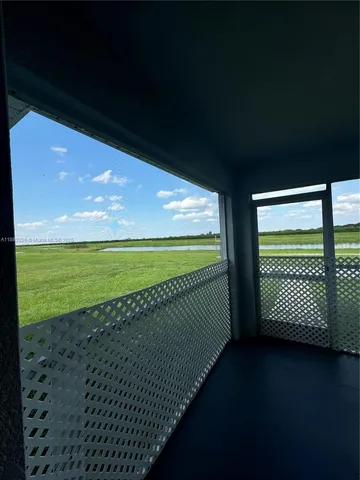 a view of a room with floor & fence