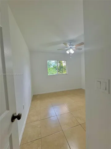 a view of an empty room and a window