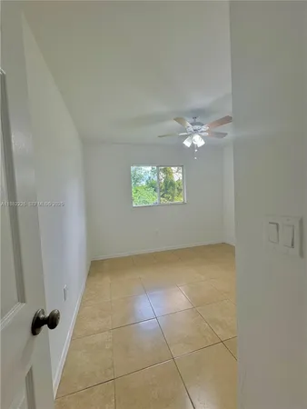a view of an empty room and a window