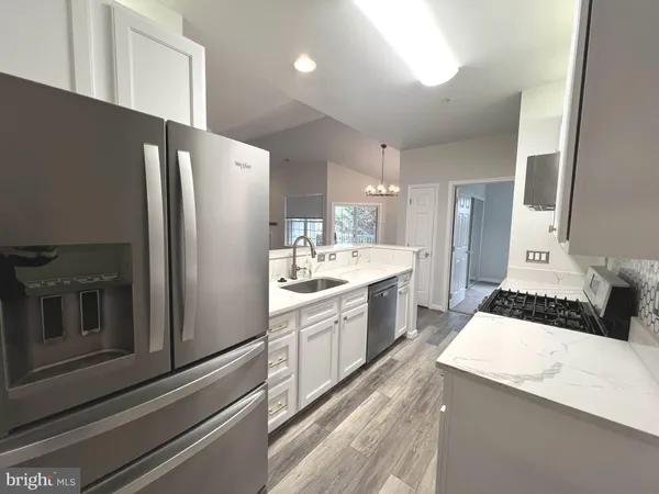 a kitchen with a refrigerator and a sink