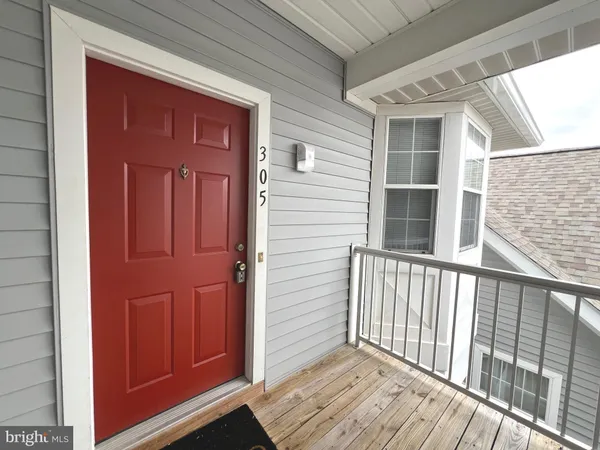 a view of a wooden door and a window