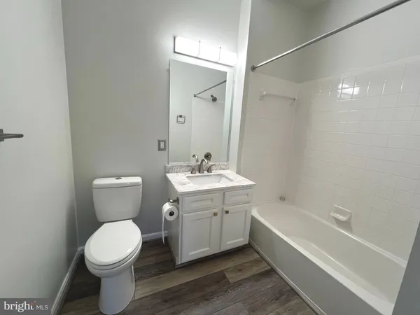 a bathroom with a toilet a sink and bathtub