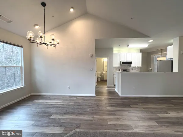 a view of a kitchen with a stove cabinets and wooden floor