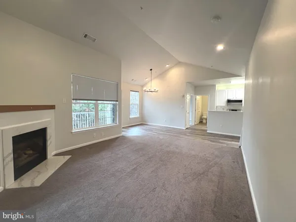 a view of a livingroom and a fireplace