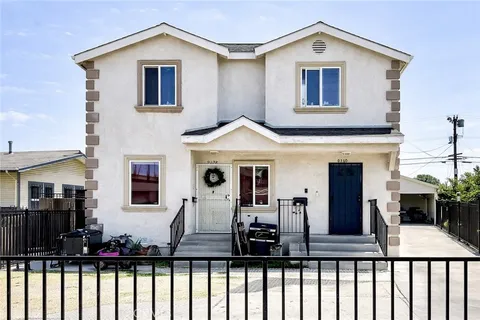 a view of a house with wooden deck