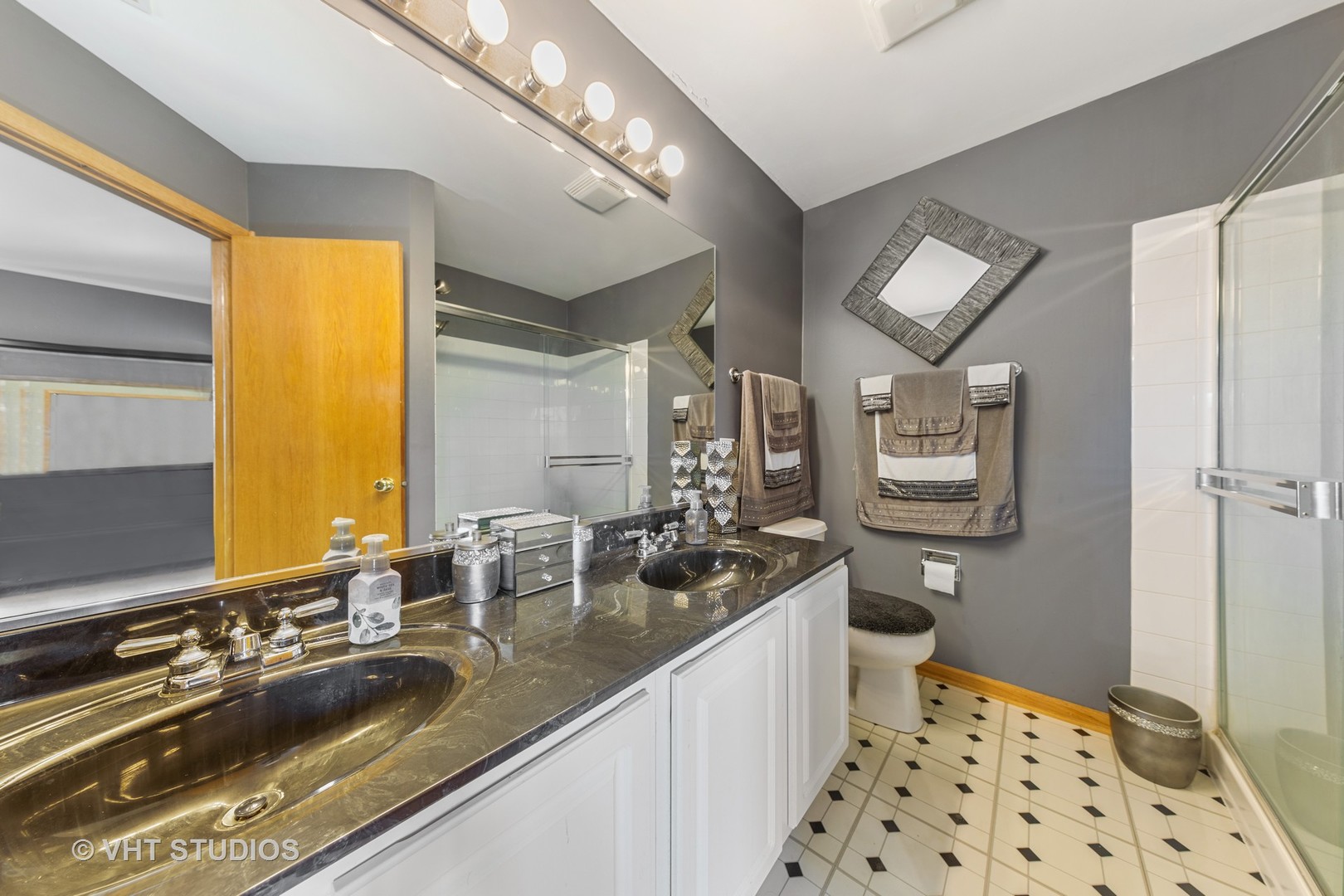 3423 Ravinia Circle Aurora, IL 60504 - Photo 13 of 17 a bathroom with a double vanity sink a mirror and a shower