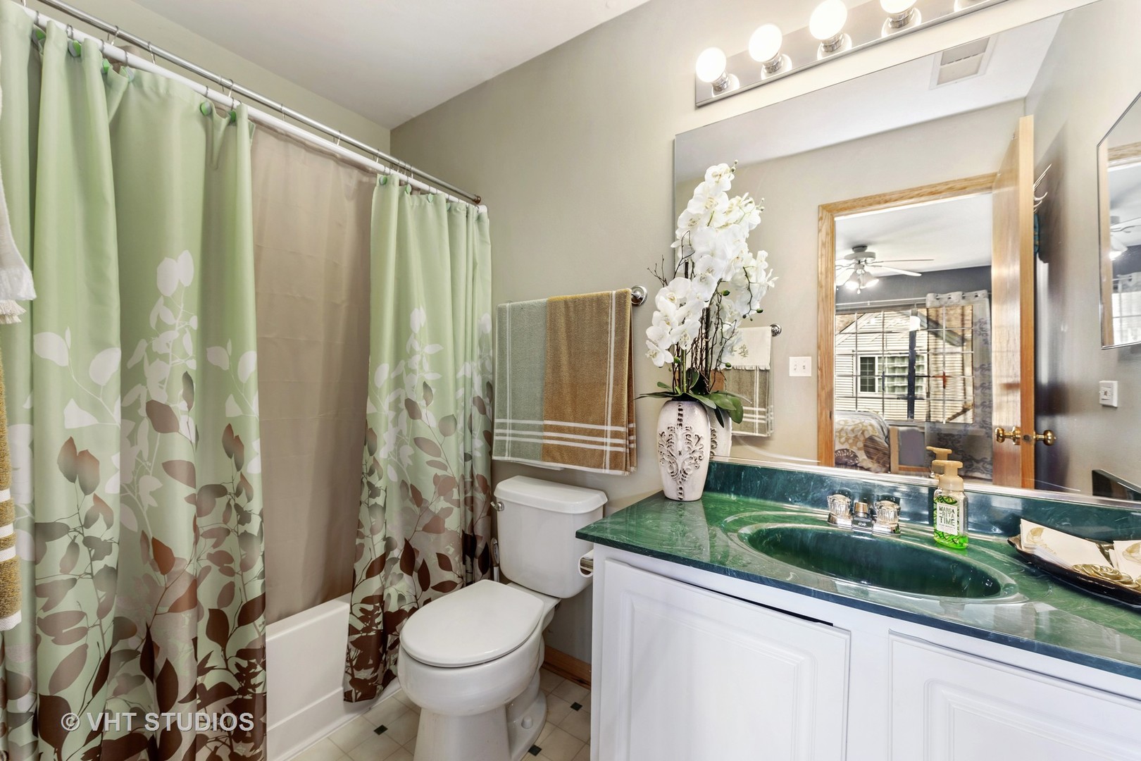3423 Ravinia Circle Aurora, IL 60504 - Photo 16 of 17 a bathroom with a granite countertop sink a toilet a mirror and shower