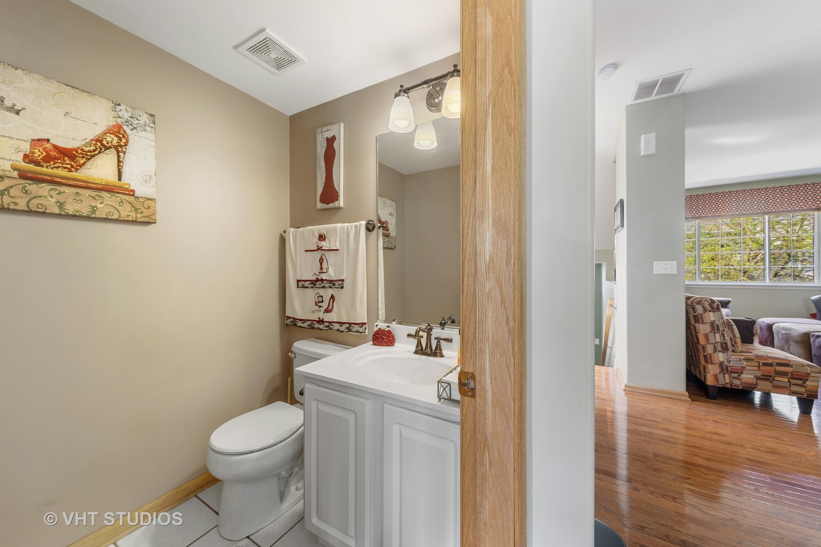 3423 Ravinia Circle Aurora, IL 60504 - Photo 8 of 17 a bathroom with a toilet sink and mirror