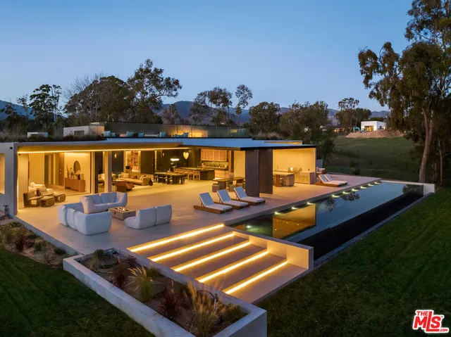 a view of swimming pool with outdoor seating and plants