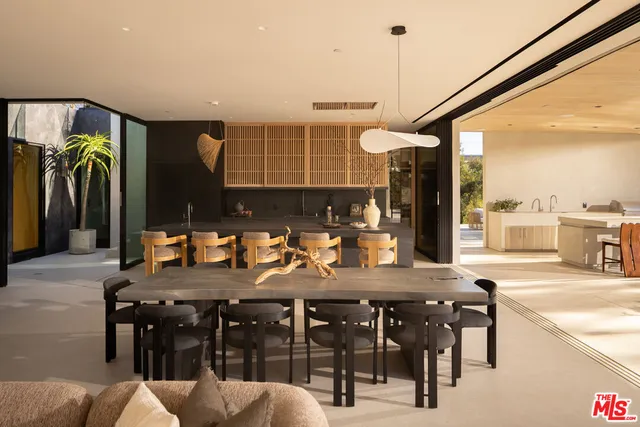 a view of a patio with table and chairs and potted plants
