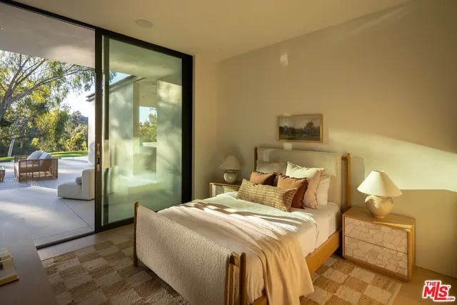 a bedroom with bed and wooden floor