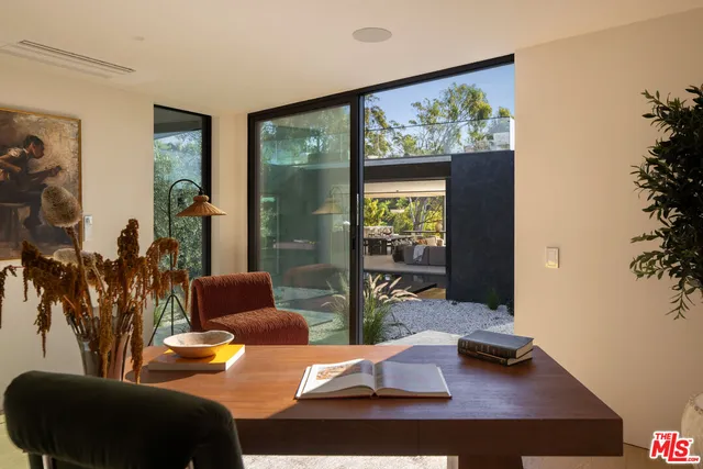 a view of a patio with a dining table and chairs with a roof deck