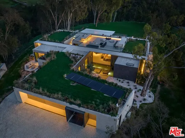 an aerial view of a house with garden space and street view