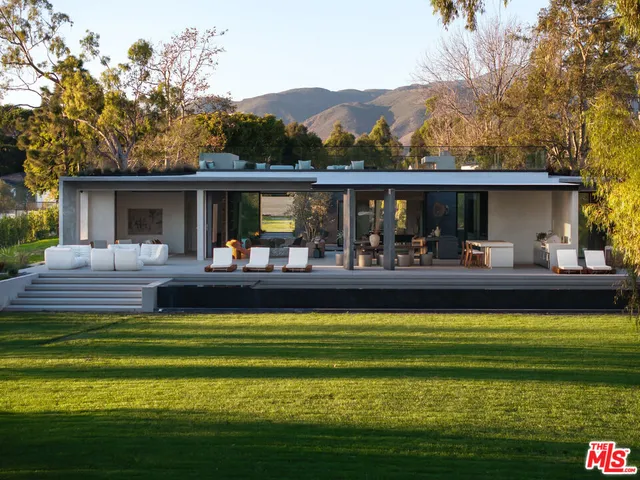 a view of swimming pool with outdoor seating and yard