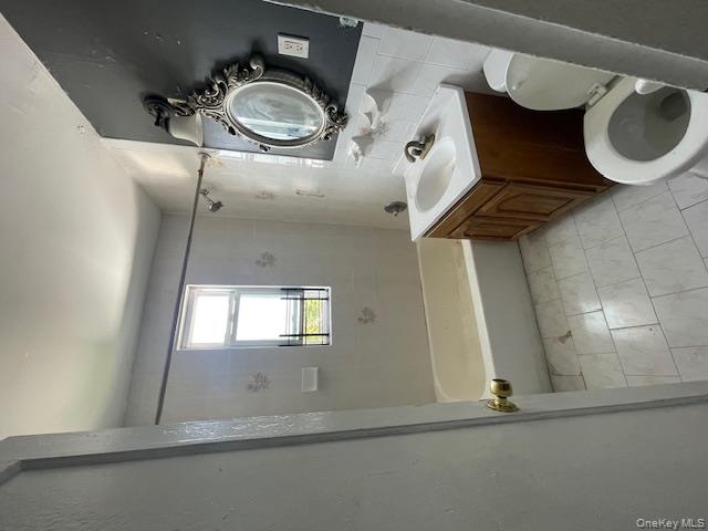 140-36 184th Street Queens, NY 11413 - Photo 4 of 15 a bathroom with a sink toilet vanity and tub