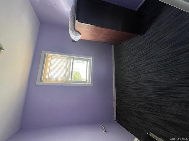 140-36 184th Street Queens, NY 11413 - Photo 5 of 15 a view of an empty room with wooden floor and a window