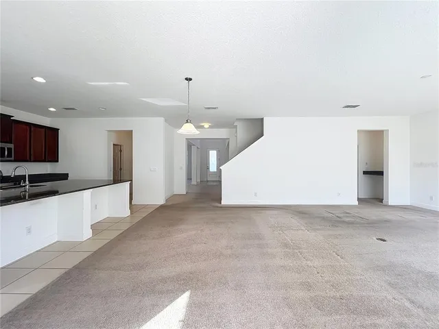 a view of a kitchen with a sink and a large window