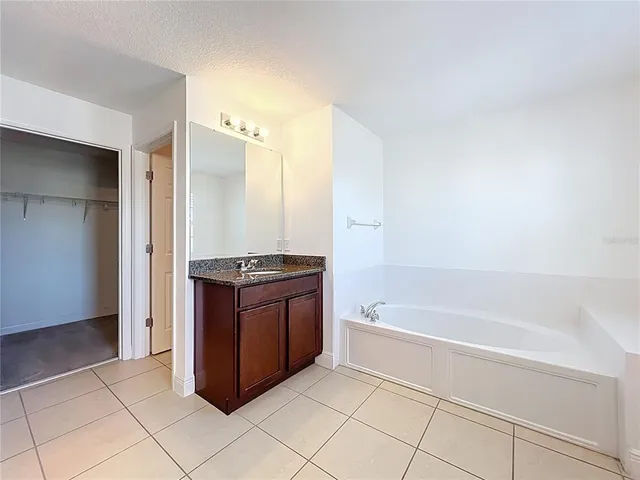 a spacious bathroom with a bathtub and a sink