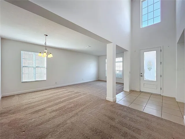 an empty room with windows and pillars in it