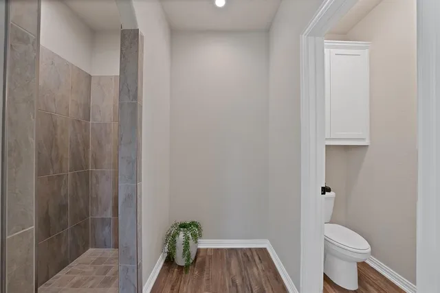 a bathroom with a toilet and a shower