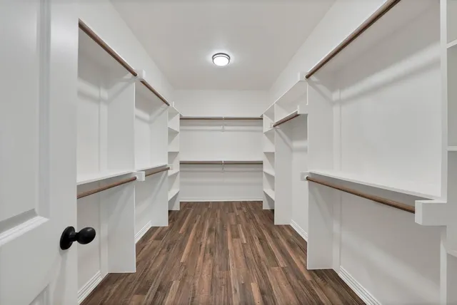 a view of walk in closet with empty racks