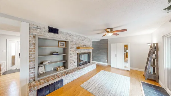 a living room with fireplace furniture and a book shelf