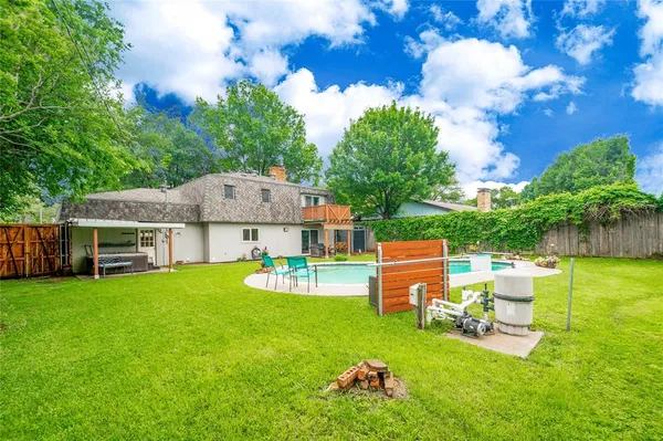 a view of a house with a big yard and large trees