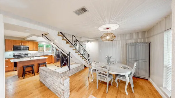a living room with dining table and a large window