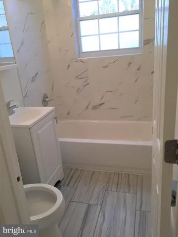 a bathroom with a sink a toilet and a bathtub