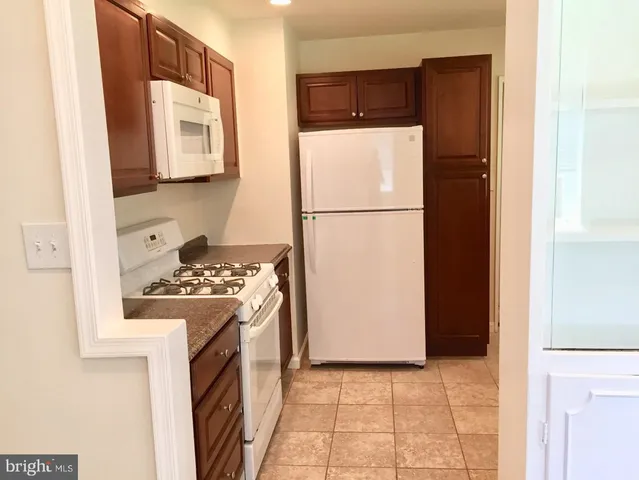 a kitchen with a refrigerator sink stove and microwave