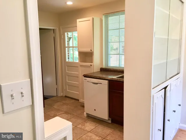 a utility room with cabinets washer and dryer