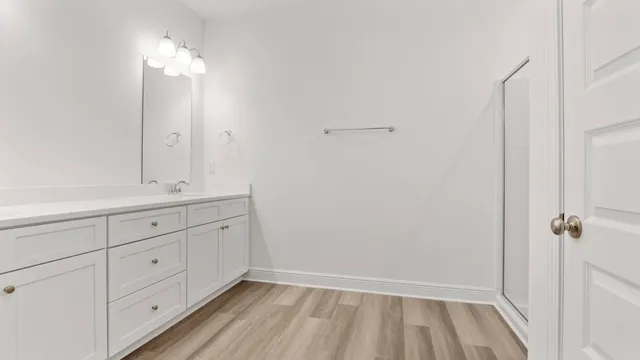 a bathroom with a double vanity sink and mirror