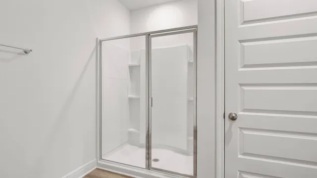 a bathroom with a glass shower door