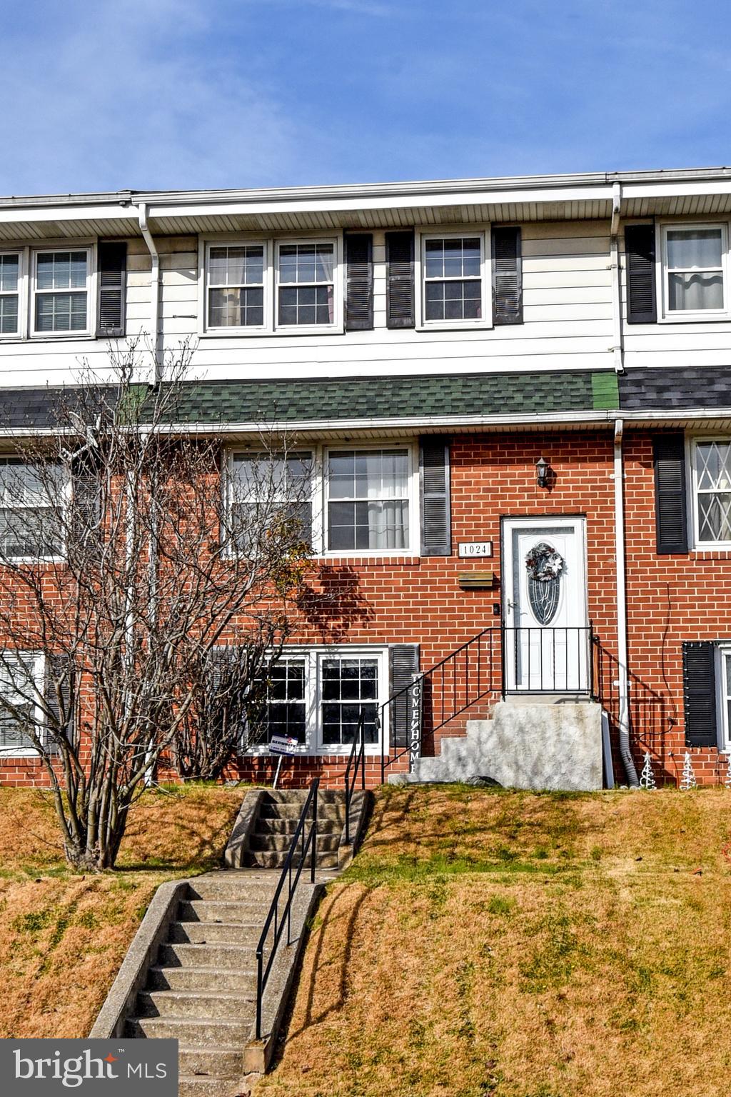 1024 Grovehill Road Baltimore, MD 21227 - Photo 1 of 39 a front view of a house with a yard