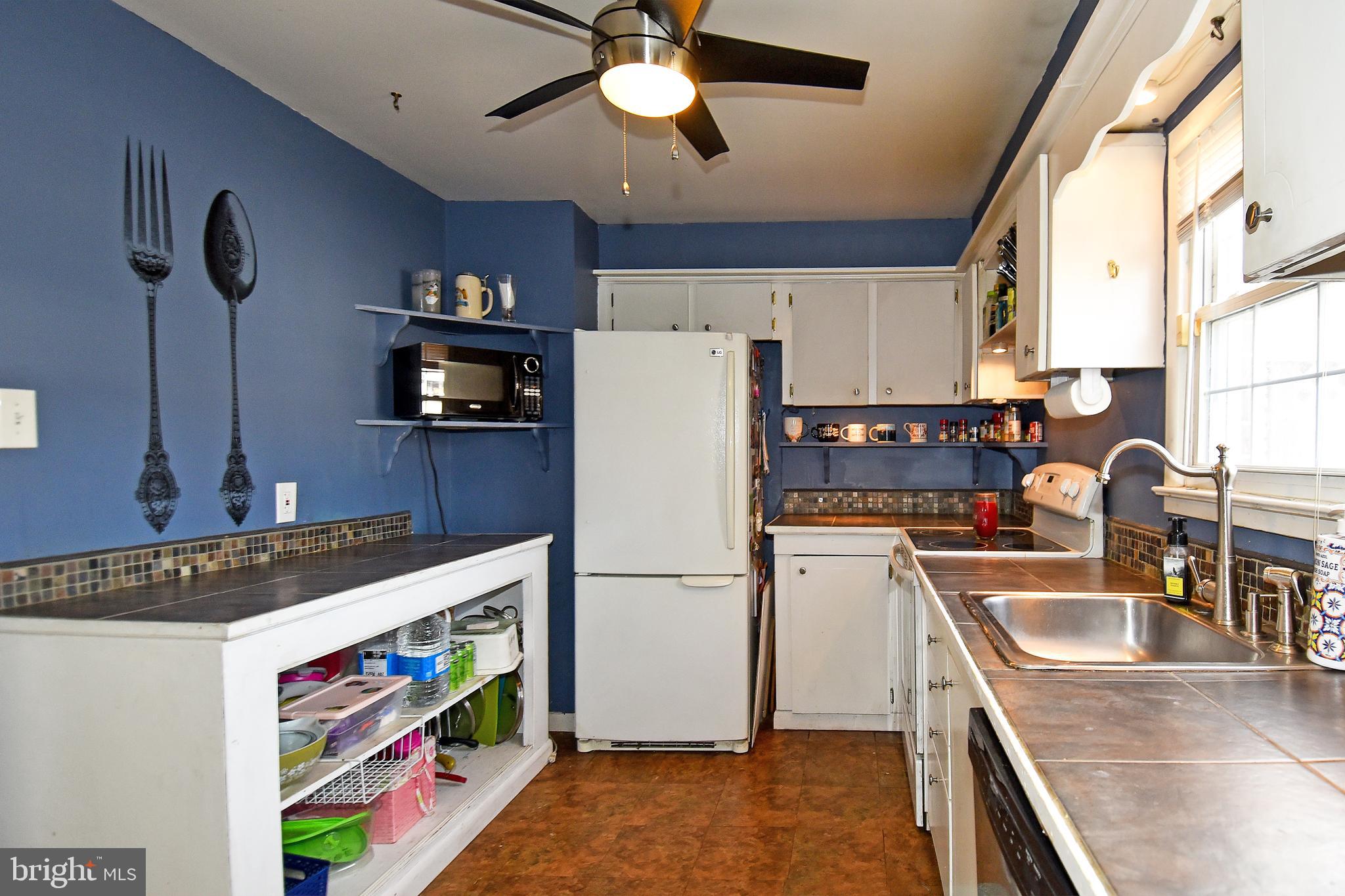 1024 Grovehill Road Baltimore, MD 21227 - Photo 15 of 39 a kitchen with stainless steel appliances granite countertop a sink stove and refrigerator