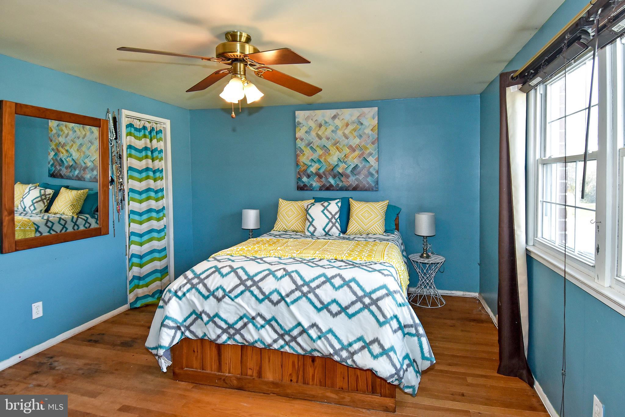1024 Grovehill Road Baltimore, MD 21227 - Photo 18 of 39 a bedroom with a bed and a chandelier