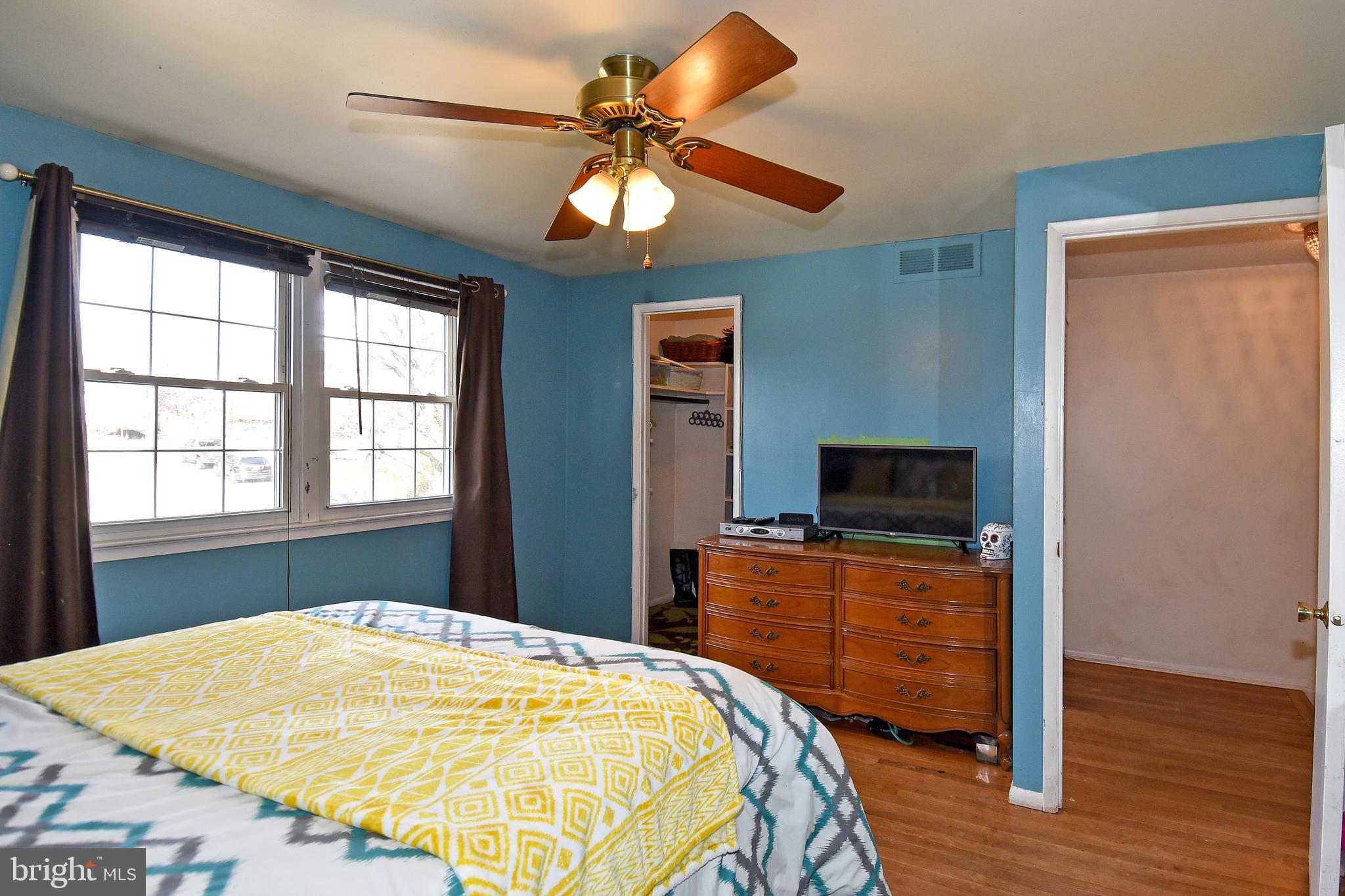 1024 Grovehill Road Baltimore, MD 21227 - Photo 19 of 39 a bedroom with a bed and a flat tv screen on dresser